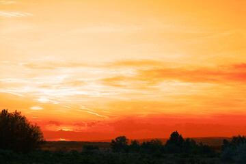 Naklejka na ściany i meble Picturesque view of beautiful orange sky at sunset