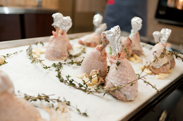 Cook preparing chicken confit leg.