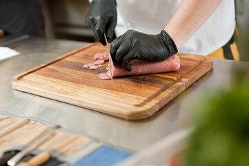 The cook cuts the meatloaf.