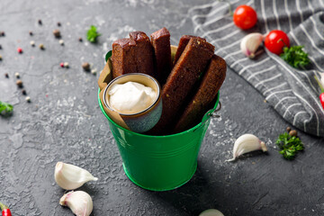 fried Garlic croutons on green bucket on grey table