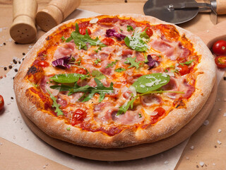 bacon pizza with tomato sauce garnished with spinach and arugula
