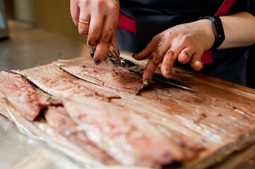 The cook separates the fillet from the fish and clears it from the bones. Mackerel fillets.