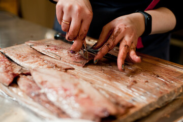 The cook separates the fillet from the fish and clears it from the bones. Mackerel fillets.