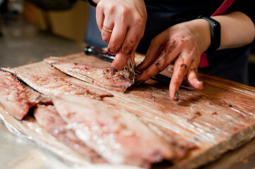 The cook separates the fillet from the fish and clears it from the bones. Mackerel fillets.