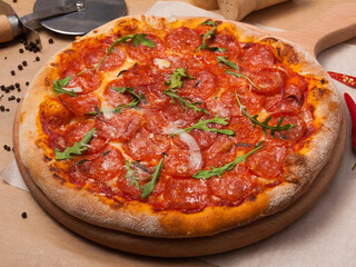 pepperoni pizza on thick dough decorated with arugula
