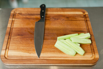 The cook cuts vegetables with a knife to prepare the dish. Cutting vegetables.