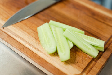 The cook cuts vegetables with a knife to prepare the dish. Cutting vegetables.
