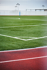 Concept: Sport. Detail of the corner of the soccer field next to the athletics track.