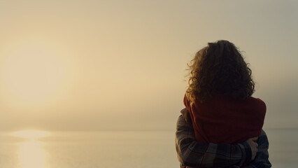 Woman and man dancing on beach at sunrise. Romantic couple hugging at sea shore