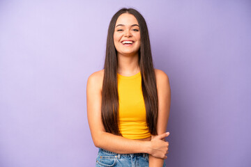 hispanic pretty woman laughing shyly and cheerfully, with a friendly and positive but insecure...