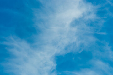 White cirrus clouds weather change wind natural background against the blue sky