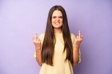 hispanic pretty woman feeling provocative, aggressive and obscene, flipping the middle finger, with...