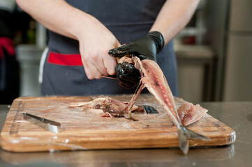 The cook separates the fillet from the fish and clears it from the bones. Mackerel fillets.