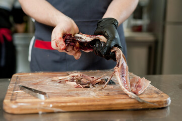 The cook separates the fillet from the fish and clears it from the bones. Mackerel fillets.
