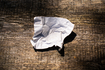 aluminum foil wrap without chocolate candy on a wooden background. Texture of used crumpled...
