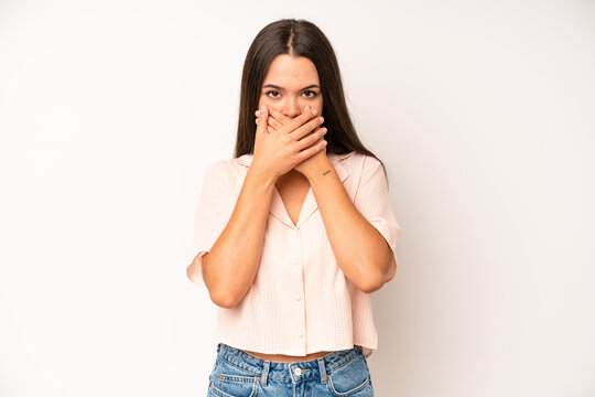 hispanic pretty woman covering mouth with hands with a shocked, surprised expression, keeping a secret or saying oops