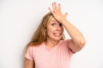blonde pretty woman raising palm to forehead thinking oops, after making a stupid mistake or...