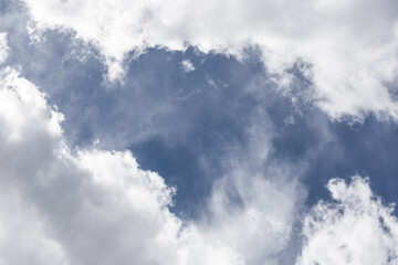 Obraz premium White cumulus clouds against a dark blue sky natural background weather change wind