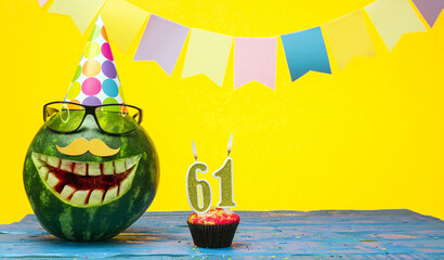 Funny watermelon in festive garlands for happy birthday greetings funny. Copy space watermelon with...