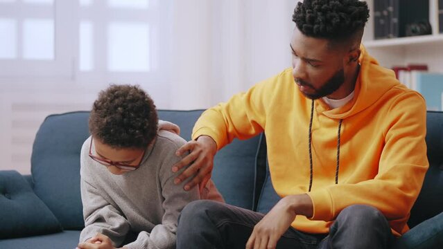 Adult young man supporting upset little boy, family care, brotherly love