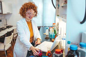 A female scientist examines samples in a laboratory, full of, state of the art research equipment....