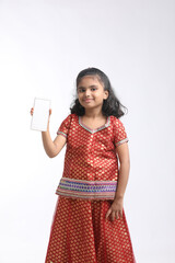 Cute indian little girl showing smartphone on white background