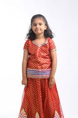 Indian little girl in traditional wear and giving expression on white background.