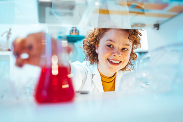 Scientist looking at test tube in the laboratory at the university. Laboratory assistant analyzing...