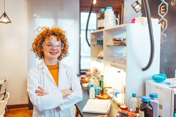 Modern laboratory interior. Woman working on medical samples in background. Shot of a young...