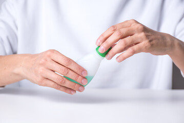  adult woman's hands opening a nail polish remover, home manicure, health and body beauty, health and body beauty.