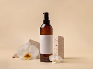 Dark glass cosmetic bottle near white orchid flowers and stones on light yellow, close up, Mockup