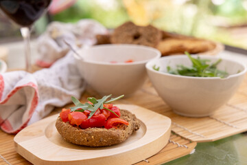Tipical summer south Italian appetizer Friselle with cherry tomatoes, oil and rucola served outdoor
