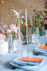Stylish beautiful luxury wedding decor with a lot of flowers, candles and number on the tables in restaurant hall