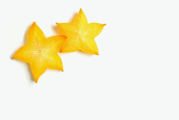 Fototapeta premium A Pair of Juicy Fresh Ripe Starfruit Slices on White Background