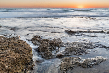 waves on the rocks in the beach Hof Hatzuk Israel