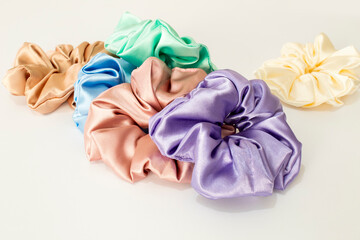 Collection of trendy silk elastic bands scrunchies on white background. Diy accessories and...