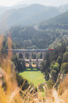 View of the Kalte Rinne railway viaduct and a passing train in Semmering, Rax-Schneeberg Group, Styria, Austria