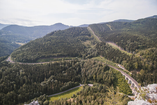 View from the rocky peak of Polleroswand of the Kalte Rinne railway viaduct and the railway cut into the mountainside, which belongs to the Rax-Schneeberg Group in the Styrian region of Austria
