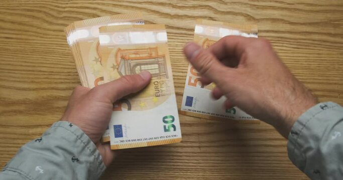 Men's hands count money, cash euro. Top view from the first person. Concept of getting a salary, credit, work, taxes, finance, payment for services, high price