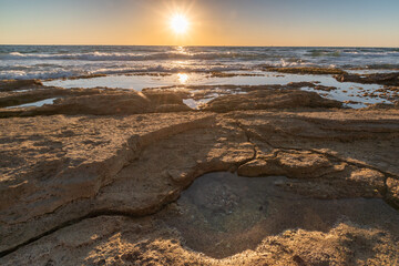 Water hole on the rocky beach Hof Hatzuk Israel