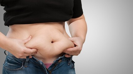 Naklejka premium Obese woman against light background. Weight loss surgery