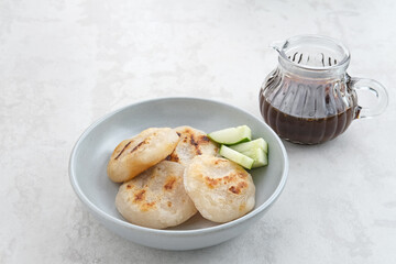 Pempek Tunu or Pempek Panggang, traditional food from South Sumatra, Indonesia. This fish-based food is very popular. Served with cuko sauce.
