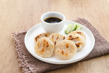 Pempek Tunu or Pempek Panggang, traditional food from South Sumatra, Indonesia. This fish-based food is very popular. Served with cuko sauce.
