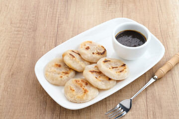 Pempek Tunu or Pempek Panggang, traditional food from South Sumatra, Indonesia. This fish-based food is very popular. Served with cuko sauce.
