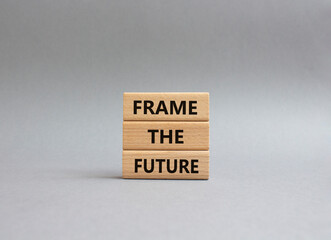 Frame the future symbol. Wooden blocks with words Frame the future. Beautiful grey background. Business and Frame the future concept. Copy space.