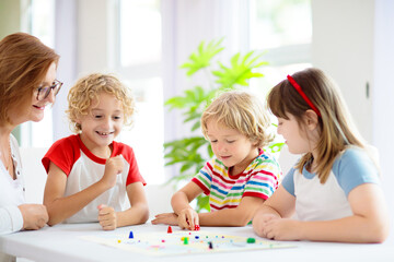 Fototapeta premium Family playing board game. Kids play.