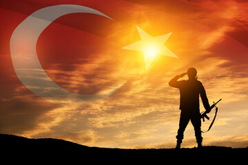 Silhouette of soldier on a background of Turkey flag and the sunset or the sunrise. Concept of...