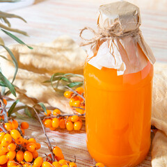 Sea buckthorn juice fresh in a homemade bottle. The concept of healthy eating, a drink from berries is a source of vitamins