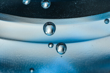 air bubbles from a water bottle on blue background