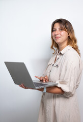 portrait d'une jolie jeune femme aux cheveux longs qui consulte son ordinateur portable. Isolé sur...